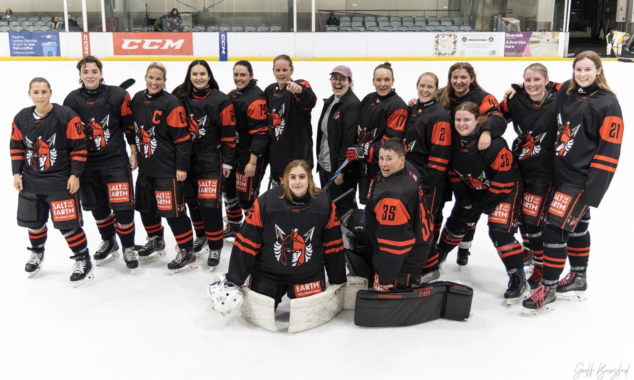 Salt of the Earth sponsored Solent Amazons women’s ice hockey team posing on the rink in black and red uniforms with visible Salt of the Earth branding, celebrating their UK partnership
